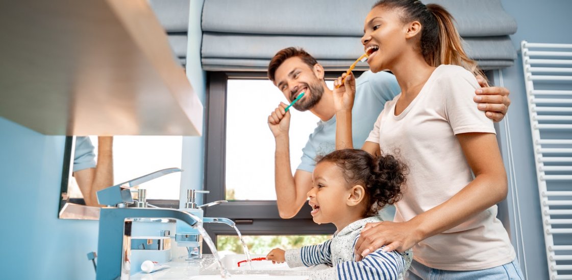 A family brushing their teeth together