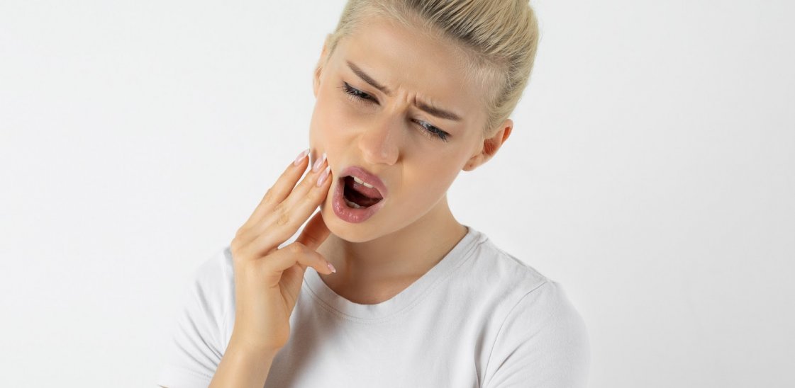 Woman with toothache in pain.