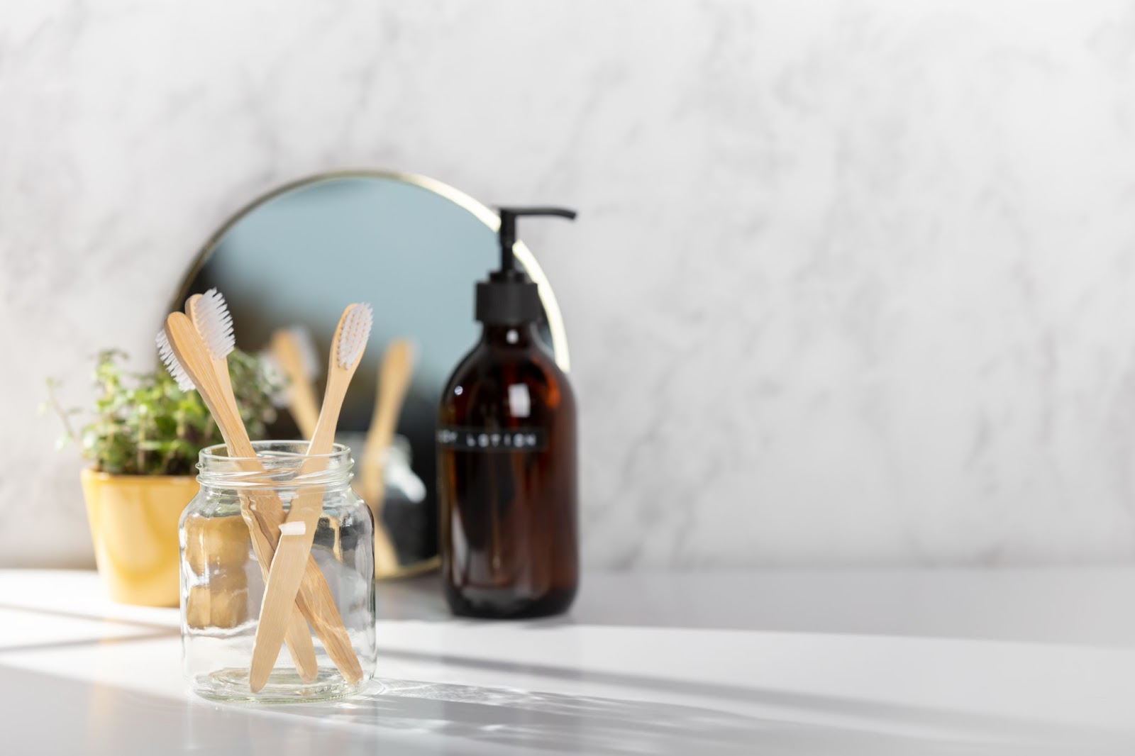 a glass bottle of soap in a marble bathroom