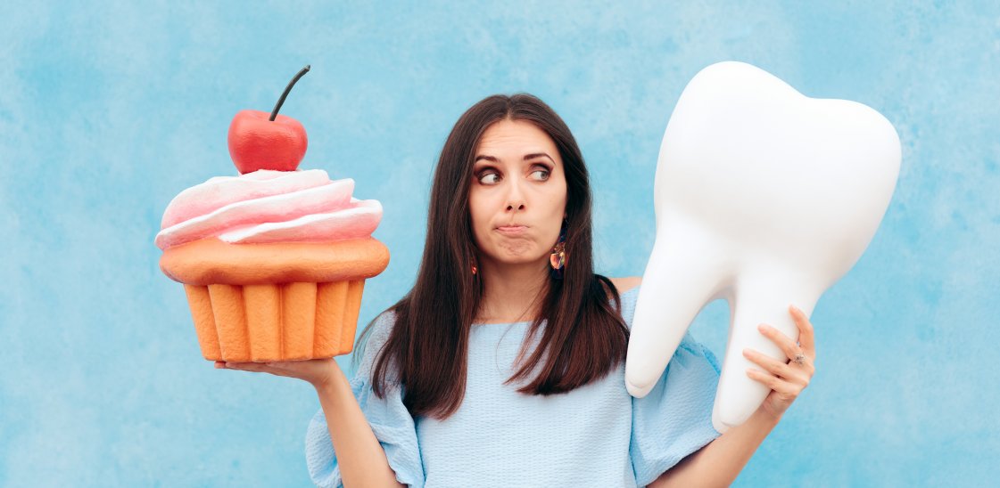 Funny Woman Holding Big Cupcake and Tooth