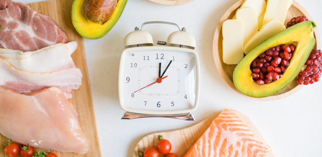 alarm clock surrounded by chopping boards and bowls of food