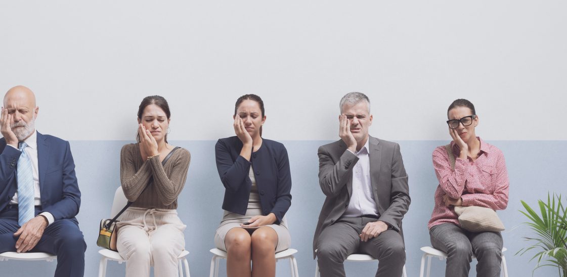 A line of people with toothache waiting to see the dentist