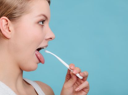 Should you scrape your tongue before or after brushing?